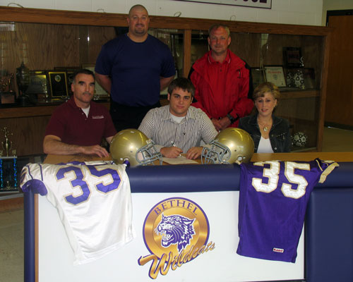 McKenzie's Jacob Fussell commits to Bethel, joined by parents Calvin & Michelle; Bethel's Dino Kaklis & MHS's Wade Comer